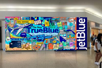 A JetBlue TrueBlue loyalty program mural at JFK